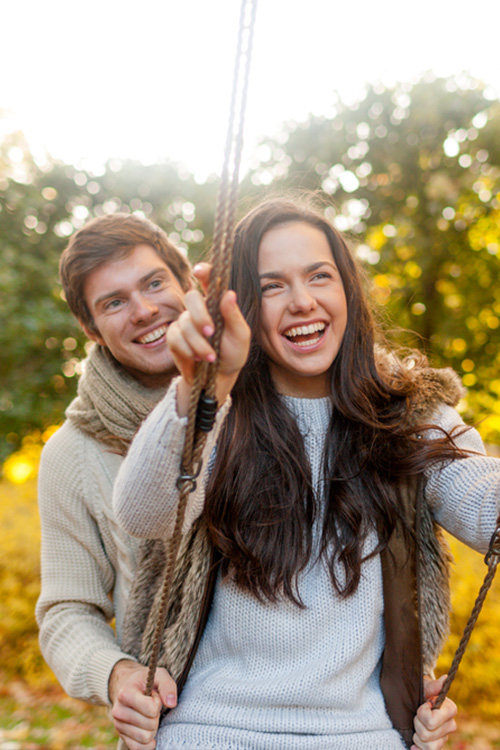 A happy couple smiling outdoors
